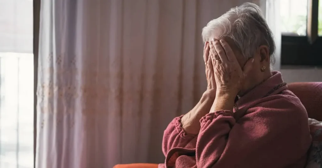 Elderly woman in distress, representing the impact of nursing home abuse